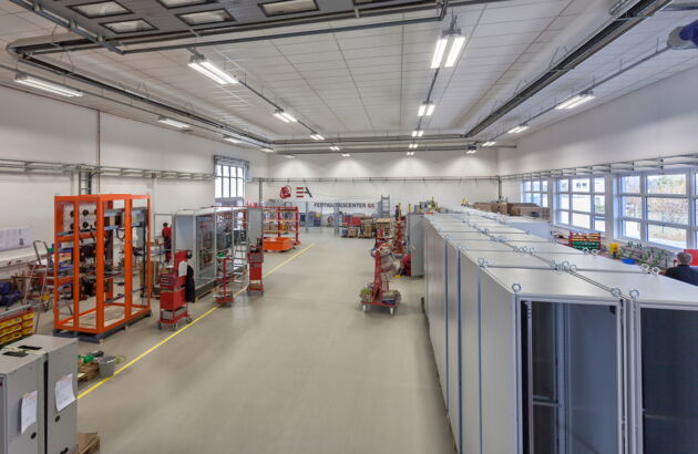 A large room with various cabinets and manufacturing processes.